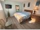 Inviting bedroom with hardwood floors, lamp, and television at 5905 South Kings Hwy. # 1116, Myrtle Beach, SC 29575
