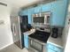 Kitchen featuring stainless steel appliances, cabinetry, and a gray backsplash at 5905 South Kings Hwy. # 1116, Myrtle Beach, SC 29575