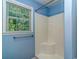 Bathroom features a walk-in shower with built-in seat, and a window providing natural light at 6001 - 1527 S Kings Hwy., Myrtle Beach, SC 29575