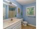 Bathroom features a single sink vanity, toilet, and large mirror, with light blue painted walls at 6001 - 1527 S Kings Hwy., Myrtle Beach, SC 29575