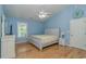 Tranquil bedroom featuring light blue walls, a whitewashed bedframe and light hardwood floors at 6001 - 1527 S Kings Hwy., Myrtle Beach, SC 29575
