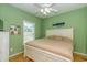 Bright bedroom with light green walls, a white bed frame, and natural light from a window at 6001 - 1527 S Kings Hwy., Myrtle Beach, SC 29575