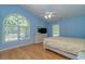 Bright bedroom with vaulted ceilings, light blue walls and large arched window, maximizing natural light at 6001 - 1527 S Kings Hwy., Myrtle Beach, SC 29575