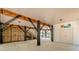 Spacious ground-level area with wooden beams, stairs to the upper level, and access to an outdoor shower at 6001 - 1527 S Kings Hwy., Myrtle Beach, SC 29575