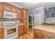 Kitchen with light countertops, wooden cabinetry, modern appliances, and open access to other areas at 6001 - 1527 S Kings Hwy., Myrtle Beach, SC 29575