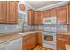 Well-lit kitchen featuring light-colored countertops, wooden cabinets, and a window overlooking the yard at 6001 - 1527 S Kings Hwy., Myrtle Beach, SC 29575