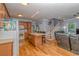 Open-concept kitchen and living room, with hardwood floors and a staircase to the upper level at 6001 - 1527 S Kings Hwy., Myrtle Beach, SC 29575