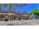 Front view of Sandy Mart, with parked golf carts, and a blue sky at 6001 - 1527 S Kings Hwy., Myrtle Beach, SC 29575
