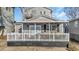 Charming gray cottage with white-railed porch, perfect for relaxing and enjoying the outdoors at 6001-5124 S Kings Hwy., Myrtle Beach, SC 29575