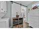 Charming laundry area with barn door and view into the living room at 6001-5124 S Kings Hwy., Myrtle Beach, SC 29575