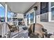 Comfortable porch setting with wicker seating and views of the surrounding neighborhood at 6001-5124 S Kings Hwy., Myrtle Beach, SC 29575