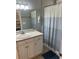 Bathroom featuring a white vanity, decorative fish, and shower curtain at 6001-O4 S Kings Hwy., Myrtle Beach, SC 29575