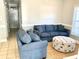 Comfortable living room with a large sofa, ottoman, and beach-themed decorations at 6001-O4 S Kings Hwy., Myrtle Beach, SC 29575