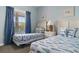 Charming bedroom with two twin beds featuring fish-themed bedding and artwork, and a large window with blue curtains at 6203 Catalina Dr. # 1822, North Myrtle Beach, SC 29582