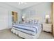 Serene bedroom featuring a queen bed with striped bedding, matching nightstands, and an ensuite bathroom at 6203 Catalina Dr. # 1822, North Myrtle Beach, SC 29582
