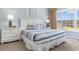 Comfortable bedroom with a queen-sized bed, blue and white bedding, and abundant natural light from a large window at 6203 Catalina Dr. # 1822, North Myrtle Beach, SC 29582