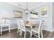 Cozy dining area features a round table with six chairs, light blue walls, and modern pendant lighting at 6203 Catalina Dr. # 1822, North Myrtle Beach, SC 29582