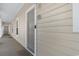 Exterior view of condo entrance featuring a gray door with number 1822 and beige siding at 6203 Catalina Dr. # 1822, North Myrtle Beach, SC 29582