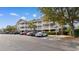 Condo building with multiple levels, balconies, and designated handicap parking space at 6203 Catalina Dr. # 1822, North Myrtle Beach, SC 29582