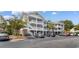Three-story condo building with white railings, brick accents, and convenient parking at 6203 Catalina Dr. # 1822, North Myrtle Beach, SC 29582