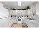 Bright kitchen with white cabinets, countertops, and a window for natural light at 6203 Catalina Dr. # 1822, North Myrtle Beach, SC 29582