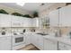 Well-lit kitchen with white appliances, cabinets, countertops, and a window view at 6203 Catalina Dr. # 1822, North Myrtle Beach, SC 29582