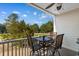 Inviting patio with four chairs and a table overlooking a serene golf course surrounded by lush trees at 6203 Catalina Dr. # 1822, North Myrtle Beach, SC 29582