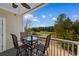 Relaxing patio with four chairs and a table, providing a picturesque view of the surrounding golf course and trees at 6203 Catalina Dr. # 1822, North Myrtle Beach, SC 29582