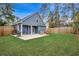 Expansive backyard featuring a patio area with outdoor seating, lush green lawn, and privacy fencing at 624 Blackberry Ave., Murrells Inlet, SC 29576
