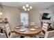 Dining room with a wooden table, six chairs, and a modern chandelier fixture at 624 Blackberry Ave., Murrells Inlet, SC 29576
