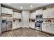 Well-lit kitchen with stainless steel appliances and white cabinets offers a clean and modern feel at 624 Blackberry Ave., Murrells Inlet, SC 29576