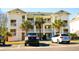 Inviting three-story condo complex featuring palm trees, private balconies, and convenient parking for residents and guests at 649 Tupelo Ln. # 13E, Longs, SC 29568