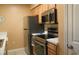 Galley kitchen equipped with stainless steel appliances and light wood cabinets at 649 Tupelo Ln. # 13E, Longs, SC 29568