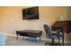 Functional living space with a wall-mounted TV, desk, and tile flooring for a comfortable at-home experience at 649 Tupelo Ln. # 13E, Longs, SC 29568