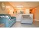 Comfortable living room with a blue sofa, armchair, tile floor, and a view to the kitchen at 649 Tupelo Ln. # 13E, Longs, SC 29568