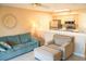 Comfortable living room with a blue sofa, armchair, tile floor, and a view to the kitchen at 649 Tupelo Ln. # 13E, Longs, SC 29568