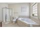 Relaxing bathroom with a tub, shower, and tiled accents, providing a spa-like experience at 703 37Th Ave. S, North Myrtle Beach, SC 29582
