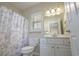 Clean bathroom featuring a shower/tub combo, white cabinets, and a well-lit vanity area at 703 37Th Ave. S, North Myrtle Beach, SC 29582