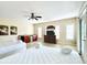 Bright bedroom features two beds, a wet bar, a dresser with a television and access to the outside at 703 37Th Ave. S, North Myrtle Beach, SC 29582