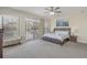 Bright bedroom featuring a king bed, neutral walls and carpet floor, along with large windows and double doors to balcony at 703 37Th Ave. S, North Myrtle Beach, SC 29582