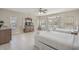 Bright bedroom features two beds, neutral walls and tile floor, along with large windows and double doors to balcony at 703 37Th Ave. S, North Myrtle Beach, SC 29582
