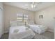 Bedroom features two beds, a ceiling fan, and natural light, offering a cozy retreat at 703 37Th Ave. S, North Myrtle Beach, SC 29582