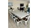 Dining area with a long white wood table and seating for 10 or more near a living room at 703 37Th Ave. S, North Myrtle Beach, SC 29582