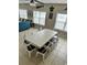 Dining area with a long white wood table and seating for 10 or more near a living room at 703 37Th Ave. S, North Myrtle Beach, SC 29582