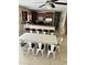 Open-concept living space with a large dining table, seating for eight, and a breakfast bar connecting to the kitchen at 703 37Th Ave. S, North Myrtle Beach, SC 29582