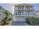 Exterior view of the multi-story beach house with two car garage and driveway at 703 37Th Ave. S, North Myrtle Beach, SC 29582