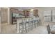 Inviting kitchen with stainless steel appliances, a breakfast bar with seating, and a view into the dining area at 703 37Th Ave. S, North Myrtle Beach, SC 29582