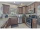 Well-equipped kitchen boasts stainless steel appliances, granite counters, and dark wood cabinets at 703 37Th Ave. S, North Myrtle Beach, SC 29582