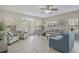 Bright living room with tile flooring, neutral walls, comfortable seating and doors leading to balcony at 703 37Th Ave. S, North Myrtle Beach, SC 29582