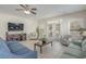 Comfortable living room with a large TV, cozy seating, and access to an outdoor patio for relaxation at 703 37Th Ave. S, North Myrtle Beach, SC 29582